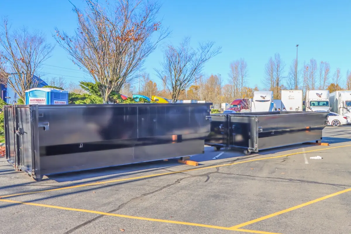 Professional dumpster rental service with roll-off container on residential driveway in Shaw Heights